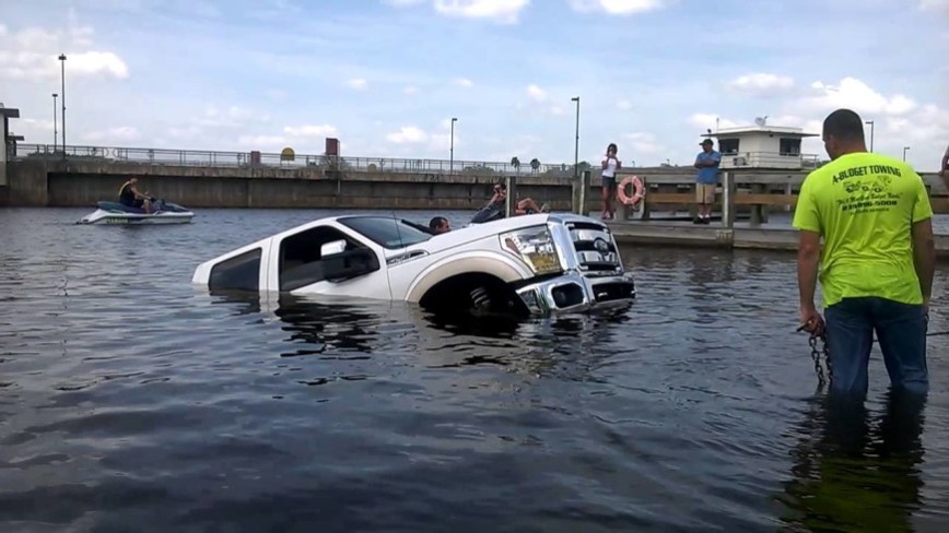 Boat launch gone bad – Guys girlfriend leaves his $70,000 truck in neutral!