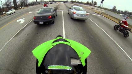 IDIOT Motorcycle RIDER Splits Cars In A Wheelie While Running Red Light