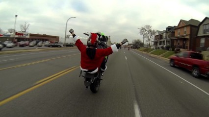 Motorcycle Riding Santa Stunting Through Town