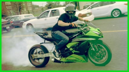 Motorcyle Stunt Rider Drifts Through City Streets