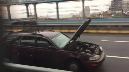 No Stopping Now – Car’s Hood Flips Open While Driving on a Bridge