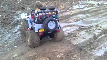 Start Em Young! Little Dude Takes Power Wheels Mud Bogging!