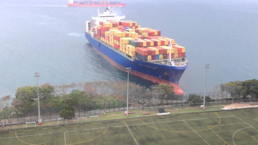 Container Ship Sails Straight to Shore by University Football Field