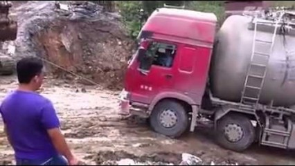 Huge Truck Falls Off Side of Muddy Hill! Slippery Slope!