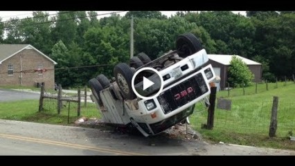 Large GMC TopKick Utility Truck Rollover