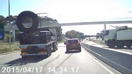 Truck Tire Falls Off Truck and Nails Car on the Freeway!