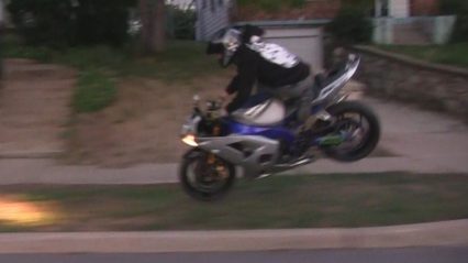 Kid showing off on his street bike eats a curb when reality strikes hard