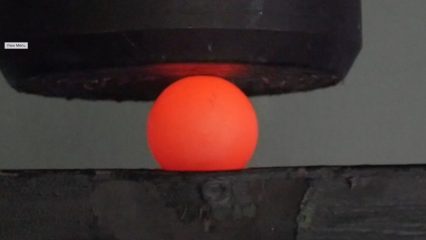 Crushing a red hot steel ball with a huge hydraulic press