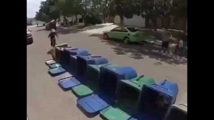 Free range parenting still exists, kid tries to jump way too many trash cans on his bike