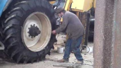 Setting the bead with fire on a huge tractor tire, redneck style