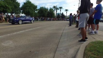 Another Ford Mustang heads straight towards a crowd at Cars and Coffee
