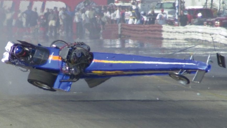 Top fuel front engine dragster crashes and snaps in half, driver walks away