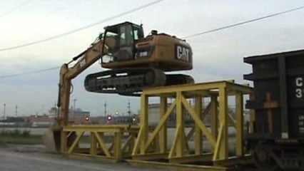 Cat 319D Excavator Climbing Onto a Rail Car, Serious Skills