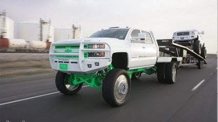 Now That is a Wild Rig… Tow truck with a Ten Inch Lift Kit Tows a MONSTER Denali HD Truck