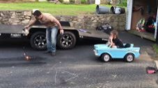 Dad Lays Down Track Prep, Daughter Wheelies in Her Power Wheels