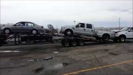 Tiny Honda Civic Pulls Huge Ford Diesel Onto SEMI Truck