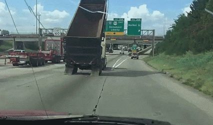 Dump truck driver crashes into highway sign at full speed