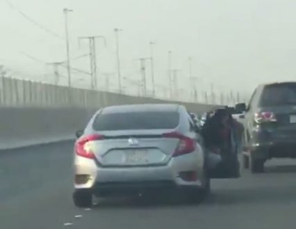 Road Rage Gone Horribly Wrong… Guy Hangs Out Window Trying to Hit Other Car