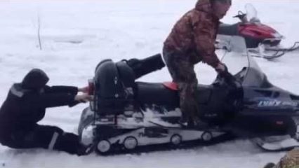 Russian Man Gets Sucked into a Snowmobile! Friends Laugh Before Helping!