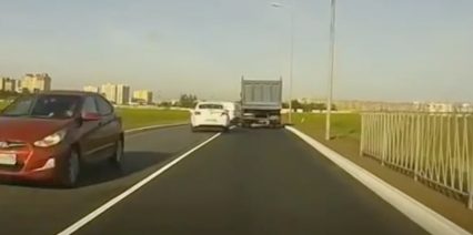 Car Trying To Cut Traffic Around A Big Truck Runs Into The Big Trucks Tire Instant Karma