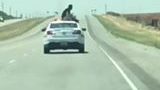 A Texas Man Sits On Top Of A Police Cruiser