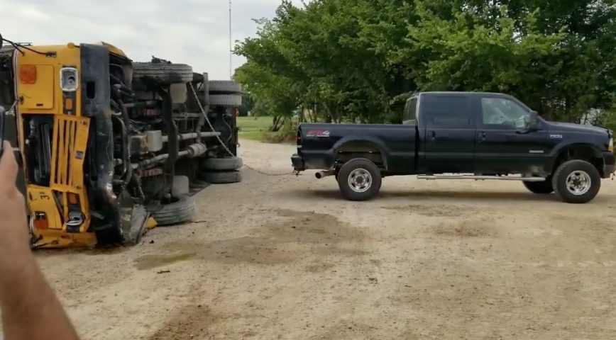 Ford Truck Struggles To Right Overturned Bus