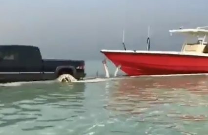Silverado On Tracks Drives Into The Surf, Pulls Out Massive Boat