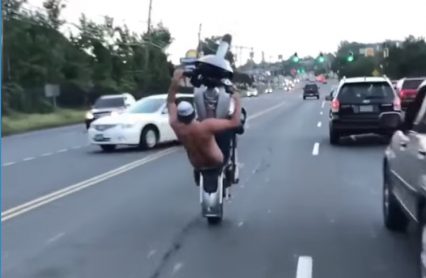 No Shirt & No Helmet, All While Doing Wild Tricks On His Harley