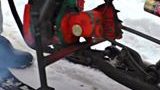 Russian Dude Fabricates A Snowmobile From A Chainsaw And A Kids Sled