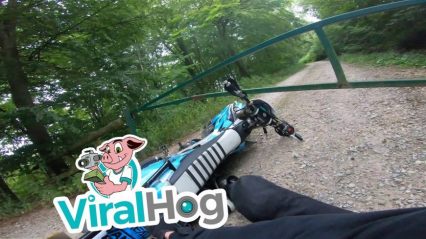 Look Out For That Gate! Dirt Bike Rider Flying Up A Trail Meets A Sudden Stop