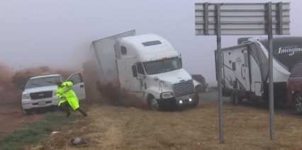Everyone Somehow Survives as Big Rig Rolls Over on Top of Parked Pickup