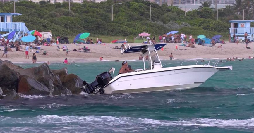 Boat Crashes Into Rocks at Haulover as People Onboard Struggle to Get Free